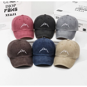 Detail of mountain embroidery on vintage washed cotton baseball caps in six diverse colors