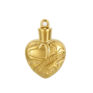 Detailed close-up of golden heart locket with intricate vintage floral carvings
