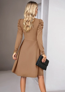 Elegant brown V-neck dress with puff sleeves and A-line skirt seen from behind