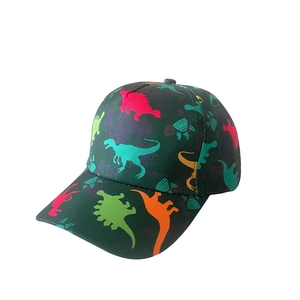 Close-up of kids baseball cap featuring vibrant dinosaur silhouette prints on dark twill fabric