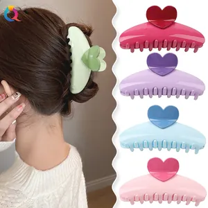 Macro shot of candy-colored heart hair claws showing diverse pastel shades and daily hairstyle