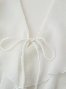 Elegant white V-neck blouse with tiered layer details and chic front bow tie design