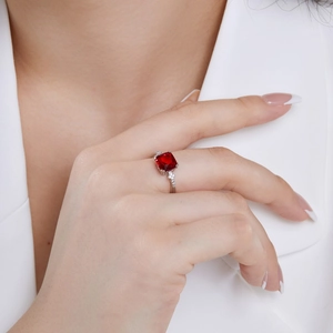 On-model view of an elegant S925 silver ring featuring a large square red gemstone and side diamonds