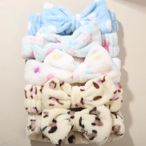 Detail of coral fleece headband set with bow tie in polka dot and leopard patterns