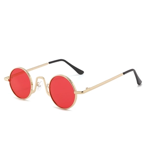 Vintage round sunglasses with red lenses and gold metal frame for a stylish street look