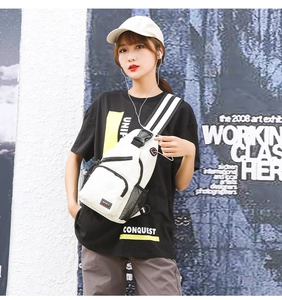 Detail of white Oxford fabric sports chest bag with side mesh pocket and sports label