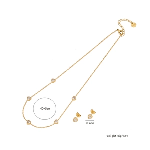 Detail of gold heart jewelry set including a 45cm necklace and 0.6cm stud earrings