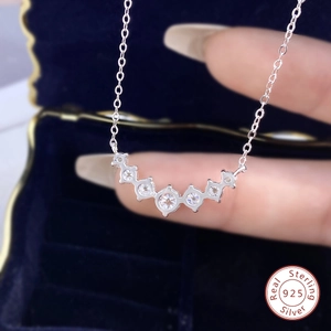 Macro shot of 925 sterling silver smile necklace with round zircons in a jewelry box