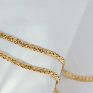 Detailed view of textured 18K gold plated snake chain with elegant metallic reflections