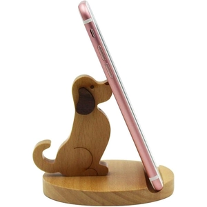 Detail of a rose gold smartphone placed on a cute wooden dog-shaped desk stand holder