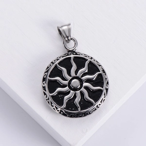 Vintage punk sunburst pendant in silver-black stainless steel on white wooden texture