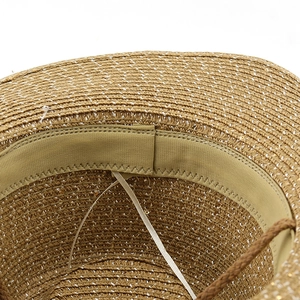 Detail of western straw hat interior showing elastic sweatband and adjustable drawstring