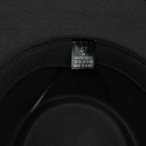 Detail of internal black sweatband and care label showing 100% polyester material