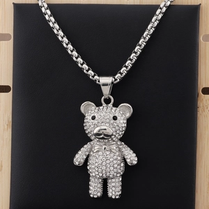 Detail of hiphop teddy bear pendant encrusted with clear crystals on a silver box chain