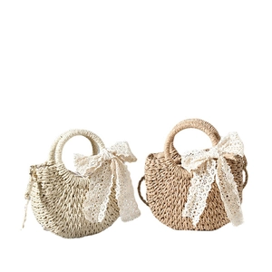 Lace bow woven straw beach bags in beige and light brown for vacation and travel