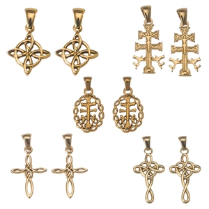 Golden Celtic knot and cross pendants in polished stainless steel on white background