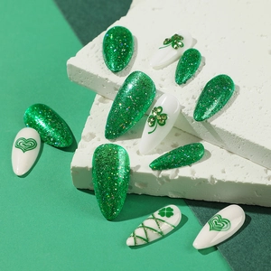 St. Patrick's Day press-on nails with green glitter, clover designs and heart patterns