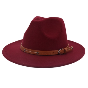 Detailed view of burgundy wool fedora featuring a brown faux leather belt with silver rivets