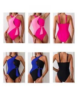 Detail view of one-piece swimsuit with asymmetrical cutouts and metal ring accents
