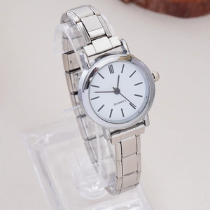 Detail of silver rhinestone elastic quartz watch on clear stand with white dial