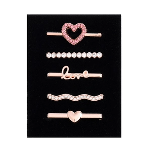 Close-up of 5-piece rose gold watch band charms with pink and white rhinestones