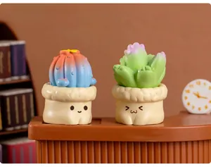 Miniature colorful resin cactus figurines with cute expressions on small desk shelf