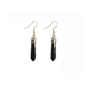 Detail showing hexagonal crystal column earrings with sparkling dark stones and silver hooks