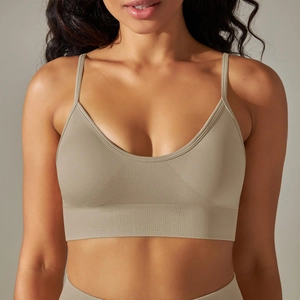 Detail of seamless knitted yoga sports bra with thin straps and ribbed texture in khaki