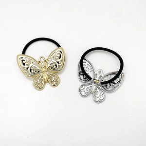 Detail of high-elasticity gold and silver hollow bow hair ties with black elastic bands
