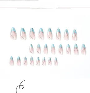 Macro shot of French almond press-on nails with blue tips and silver glitter wave lines