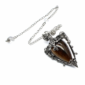 Macro shot of silver retro pendant featuring tiger eye stone and pentagram star detail