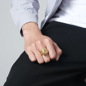 Men's gold lion head ring in titanium steel on model with detailed metal texture