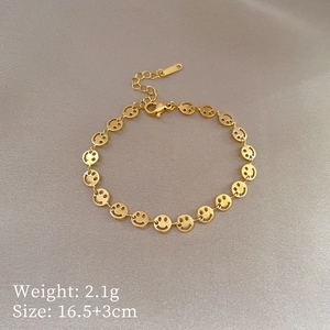 Detailed shot of gold smiley face chain bracelet with length and weight specifications