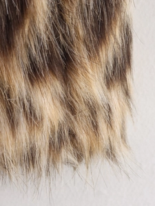 Close-up of luxury leopard print faux fur texture with soft brown and black fibers