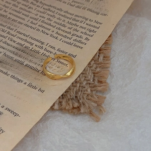 Macro shot of minimalist twisted S925 sterling silver ring with gold plating finish