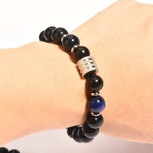 Detailed view of men's beaded bracelet with tiger eye obsidian beads on wrist