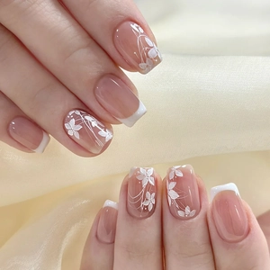 Elegant French nude short square press-on nails with white floral patterns and silk backdrop