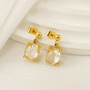 Elegant gold-plated oval zircon drop earrings on a minimalist white display stand