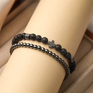 Tiger Eye stone and lava bead bracelet set with silver cross on a jewelry display stand