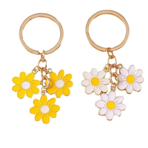 Golden daisy flower keychains with white and yellow enamel charms for handbags