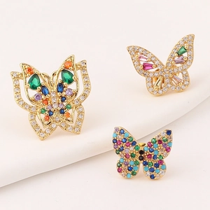 Three gold butterfly earrings with colorful zircon stones on a white background