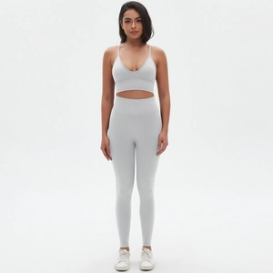 Front view of grey seamless yoga set featuring a deep V-neck bra and high waist leggings