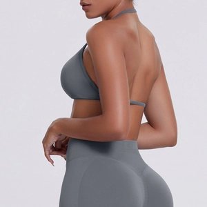 Detail view of charcoal grey ribbed high-waist yoga leggings and halter sports bra