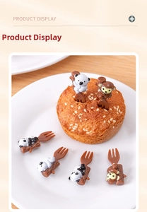 Detailed view of panda and koala bento picks on small cakes over a wooden table