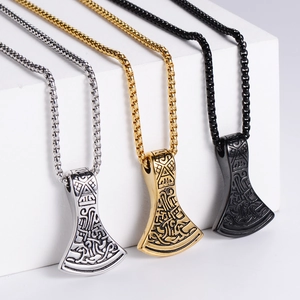 Detailed view of Viking axe pendants in silver, gold, and black with Norse engravings