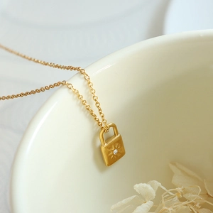 18k gold plated stainless steel padlock pendant necklace with sunburst zircon detail