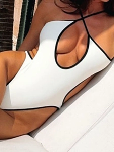 Sexy white one-piece swimsuit with black trim, halter neck and front cutout design