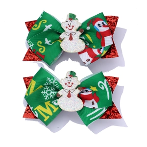 Set of two handmade Christmas bow hair clips with red sequins and green snowman motifs