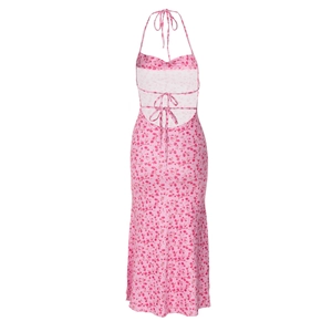 Detail of pink floral halter dress showing backless design with tie-up closure