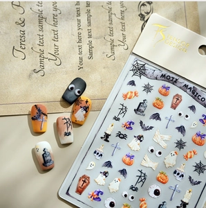 Macro detail of Halloween nail stickers featuring ghost, pumpkin, and bat designs